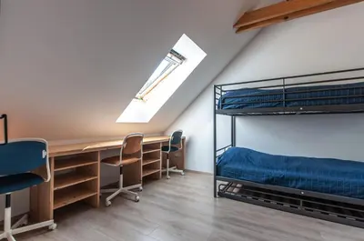 a room with a desk and bunk beds at Bohinj Barn in Bohinj
