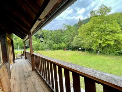 a porch of a cabin with a view of a park at Bohinj Barn in Bohinj