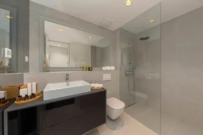 a bathroom with a sink and a toilet and a shower at Skyline Luxury Residence Jana in Ljubljana