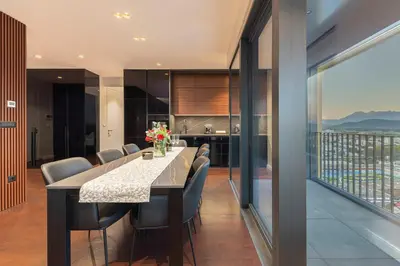 a kitchen and dining room with a long table and chairs at Skyline Luxury Residence Jana in Ljubljana