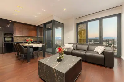 a living room with a couch and a table at Skyline Luxury Residence Jana in Ljubljana