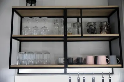 a shelf with glasses and other items on it at Apartma Verdi Bc in Bovec