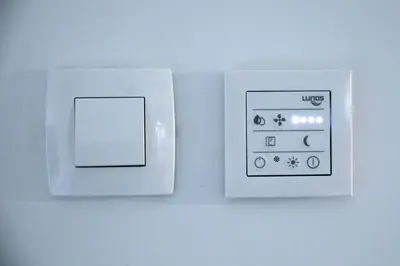 a white light switch on a white wall at Apartma Verdi Bc in Bovec