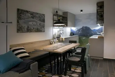 a kitchen with a table and chairs in a room at Apartma Verdi Bc in Bovec