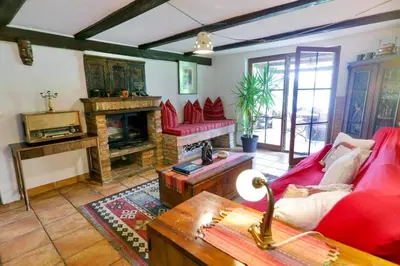 a living room with red furniture and a fireplace at Lake House with a View in Šmartno v Rožni Dolini