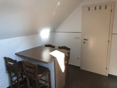 a room with a table and chairs and a door at APARTMA AJDA in Kranj