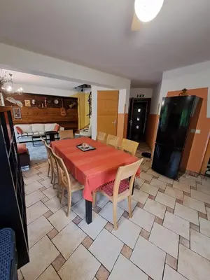 a dining room with a red table and chairs at Family House in Mozirje