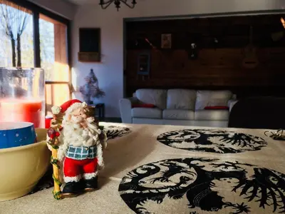 a santa claus figurine sitting on a table at Family House in Mozirje