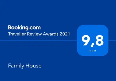 a blue house with the text travel review awards at Family House in Mozirje