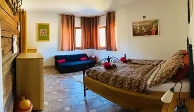 a bedroom with a bed and a couch in it at Family House in Mozirje