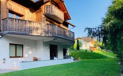 a house with a balcony and a yard at Family House in Mozirje