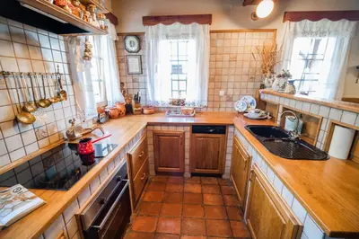 a large kitchen with wooden counters and a sink at Authentic Countryside Villa with Hot tub in Veliki Kamen