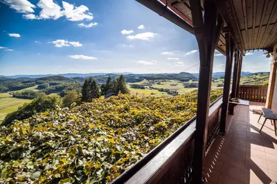 a balcony of a house with a view of the mountains at Authentic Countryside Villa with Hot tub in Veliki Kamen
