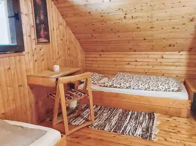 a log cabin with a bed and a desk at Peaceful Nature Cabin Jolly in Mozirje