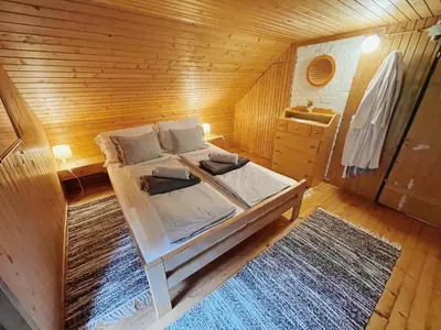 a bedroom with a bed in a wooden room at Peaceful Nature Cabin Jolly in Mozirje