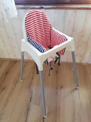 a white chair with a red and white blanket on it at Alpeambient house Dovje in Mojstrana
