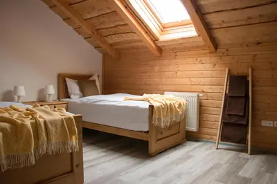a bedroom with two beds and a skylight at Ranch Kamovci21 in Dobrovnik