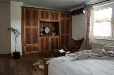 a bedroom with a bed and a wooden cabinet at Ranch Kamovci21 in Dobrovnik