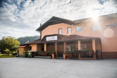 a building with a parking lot in front of it at Rooms at Trimček in Sevnica
