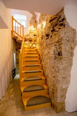 a staircase in a cave with a rock wall at Holiday country house Gora in Gozd