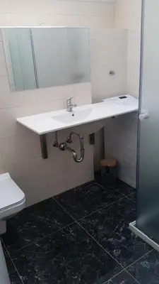 a bathroom with a white sink and a toilet at Holiday country house Gora in Gozd