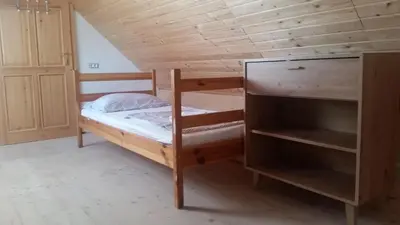 a bedroom with a bunk bed and a wooden ceiling at Holiday country house Gora in Gozd