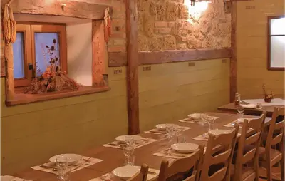 a dining room with tables and chairs and a mirror at 4 Bedroom Lovely Home In Kostel in Kupa