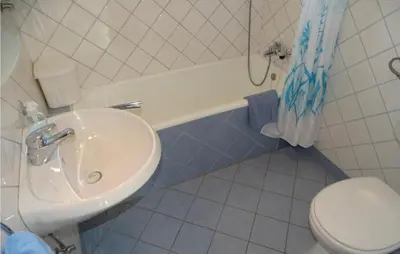 a bathroom with a sink and a toilet and a tub at 4 Bedroom Lovely Home In Kostel in Kupa
