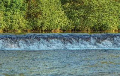 a river with a waterfall and trees in the background at 4 Bedroom Lovely Home In Kostel in Kupa
