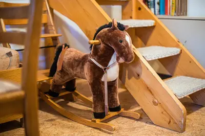 a stuffed horse is standing in a toy tent at Tree Top Rogla Apartment in Zreče