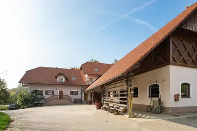 a large white building with a bunch of bikes parked outside at APARTMENT ZYNGA - STUD FARM in Šentvid pri Stični