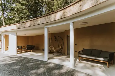 a house with a black couch on a patio at Falkensteiner Premium Camping Lake Blagus in Sveti Jurij ob Ščavnici
