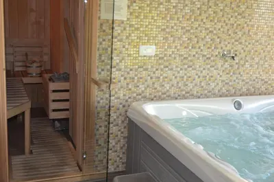 a bathroom with a bath tub and a shower at Holiday Home with Hot tub and Sauna Sabina in Rovte