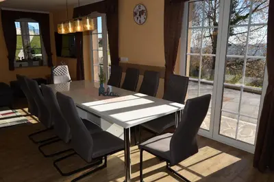 a dining room with a white table and chairs at Holiday Home with Hot tub and Sauna Sabina in Rovte