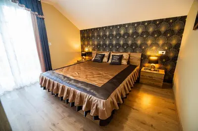 a bedroom with a large bed with a large headboard at Holiday Home with Hot tub and Sauna Sabina in Rovte