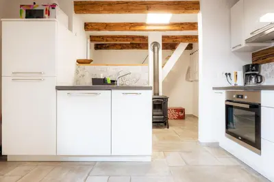 a kitchen with white cabinets and a stove at Apartment VILLA IRENA Great For a Family Holiday With Free Parking And EV Station in Ajdovščina