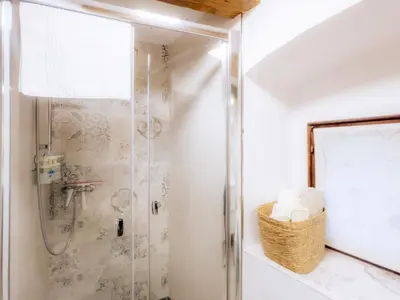 a bathroom with a shower with a basket of towels at Apartment VILLA IRENA Great For a Family Holiday With Free Parking And EV Station in Ajdovščina