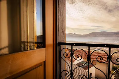 a balcony with a view of the mountains at Apartment VILLA IRENA Great For a Family Holiday With Free Parking And EV Station in Ajdovščina