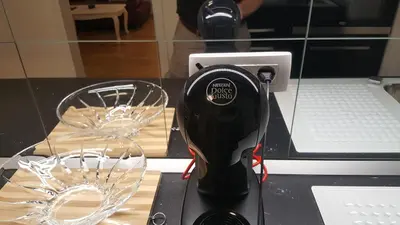 a hair dryer sitting on a counter next to a glass at E&E Apartments 4* Arena Stožice in Ljubljana