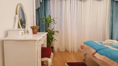 a bedroom with a bed and a dresser and a mirror at E&E Apartments 4* Arena Stožice in Ljubljana