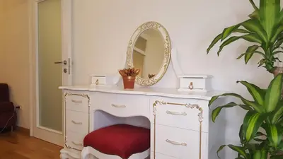 a dressing table with a mirror on top of it at E&E Apartments 4* Arena Stožice in Ljubljana