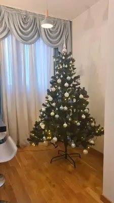 a christmas tree sitting in a living room at E&E Apartments 4* Arena Stožice in Ljubljana