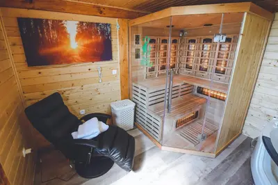 a bathroom with a shower and a chair in it at Apartments Jernej with Onsite Wellness in Brežice