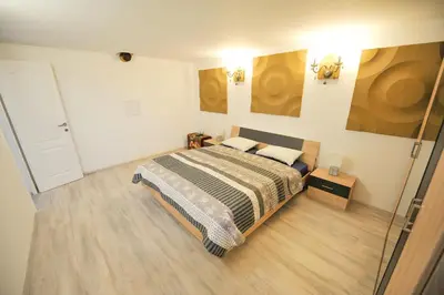 a bedroom with a bed and a glass door at Apartments Jernej with Onsite Wellness in Brežice