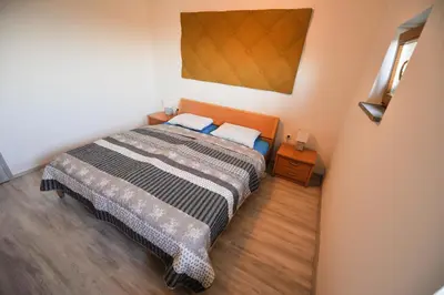 a bedroom with a bed and a painting on the wall at Apartments Jernej with Onsite Wellness in Brežice