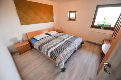 a small bedroom with a bed and a window at Apartments Jernej with Onsite Wellness in Brežice