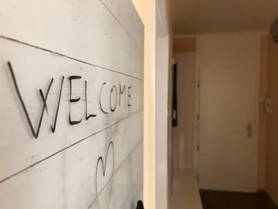 a wall with the word welcome written on it at APARTMA CARPE DIEM in Kranjska Gora