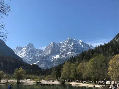 a mountain view of a lake with snow covered mountains at APARTMA CARPE DIEM in Kranjska Gora