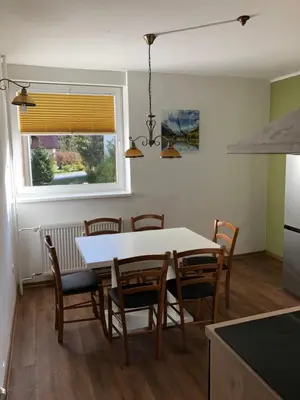 a kitchen and dining room with a table and chairs at APARTMA CARPE DIEM in Kranjska Gora