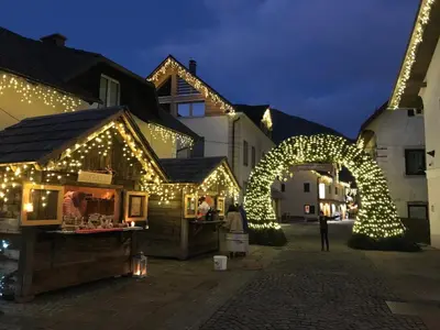 a street with christmas lights and a building at APARTMA CARPE DIEM in Kranjska Gora